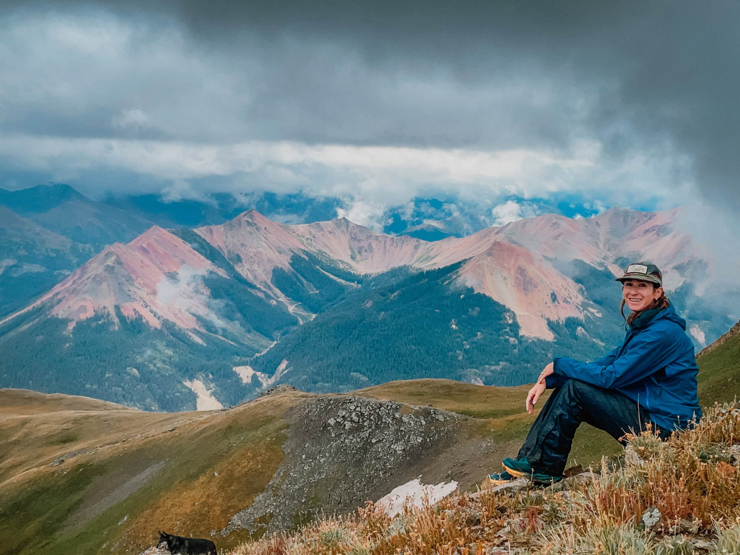 woman smiling hiking in mountains