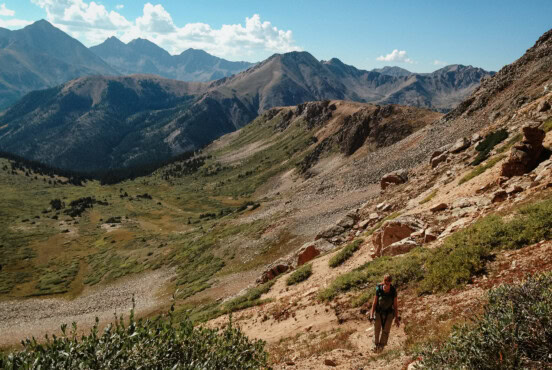 Woman hiking down a trail