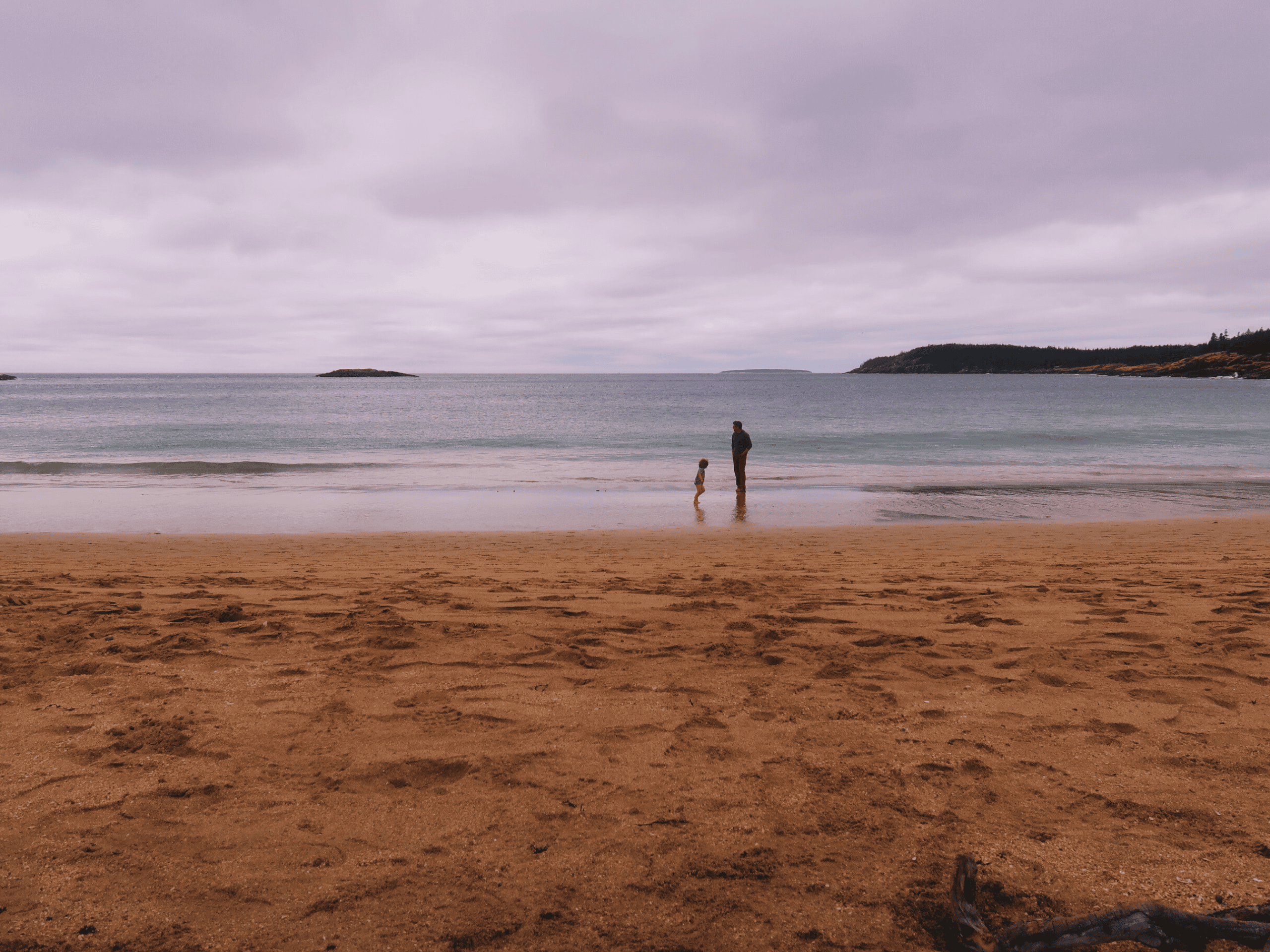 A man and his child on Sand Beach