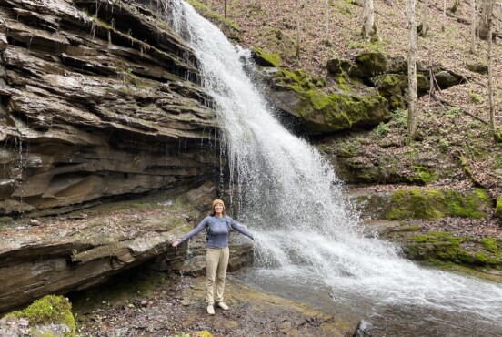 Big Branch Falls with woman standing in front with her arms open