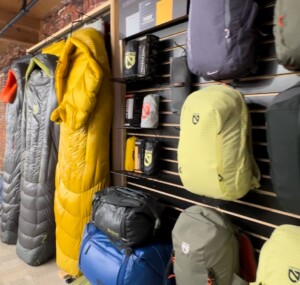 Sleeping bags and backpacks hanging on wall